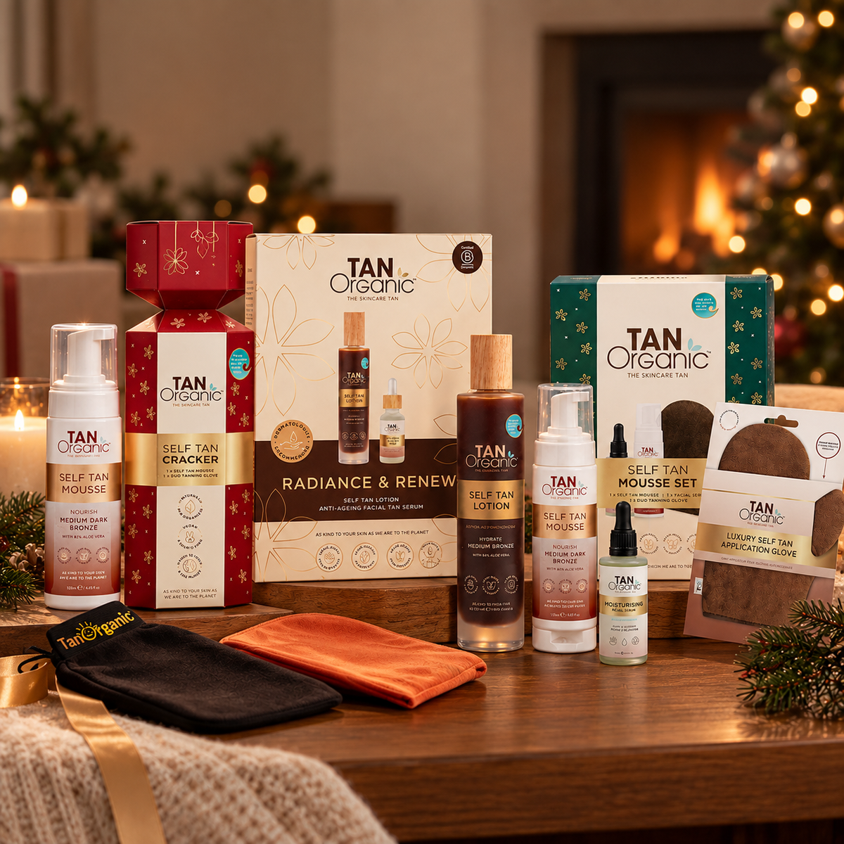 TanOrganic Self Tan Mousse Set beside a decorated Christmas tree